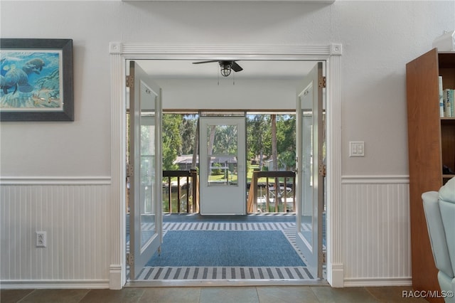 doorway to outside featuring tile patterned floors and ceiling fan