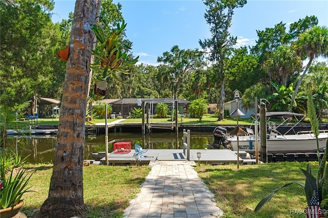 dock area featuring a lawn and a water view