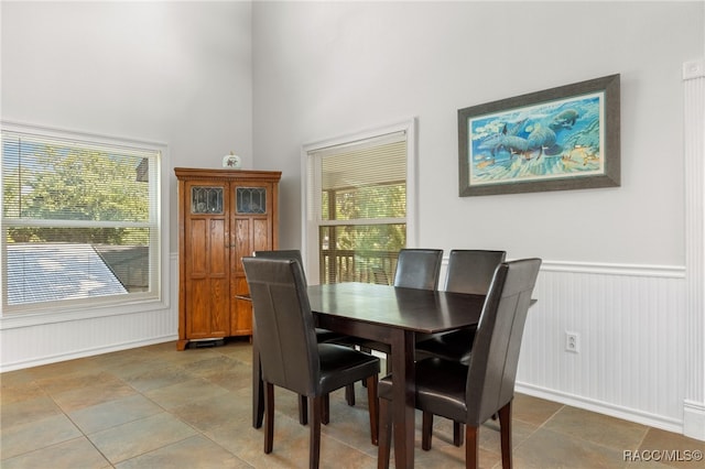 dining area featuring a towering ceiling