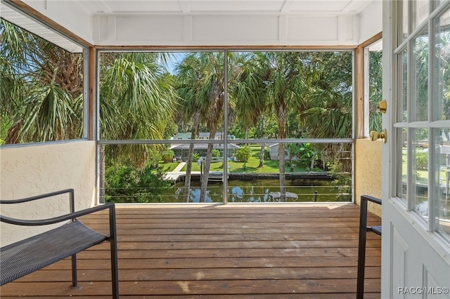 sunroom / solarium with plenty of natural light and a water view