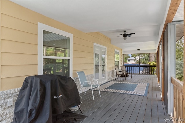 wooden deck featuring french doors, area for grilling, a porch, and ceiling fan