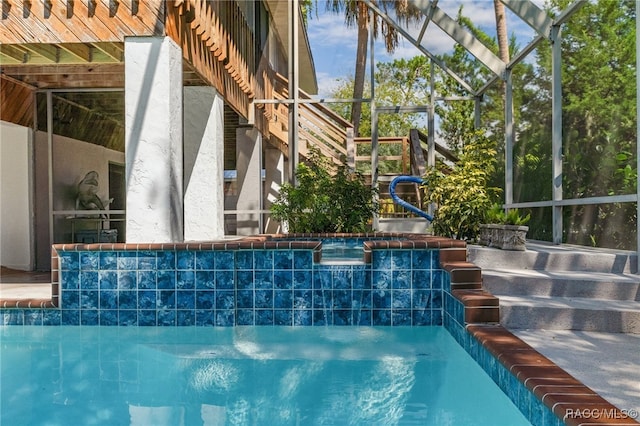 view of pool with a hot tub