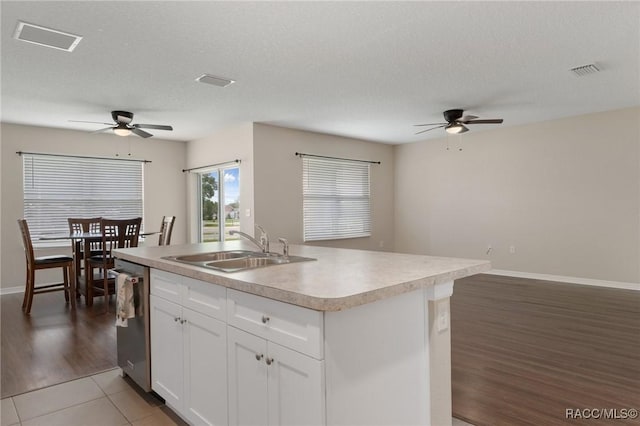 3417 N Michener Pt Unit 2C, Beverly Hills, FL 34465 - kitchen featuring a ceiling fan, a kitchen island with sink, light countertops, white cabinets, and a textured ceiling