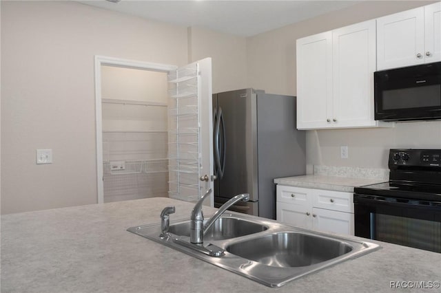 3417 N Michener Pt Unit 2C, Beverly Hills, FL 34465 - kitchen with black appliances, white cabinetry, and light countertops