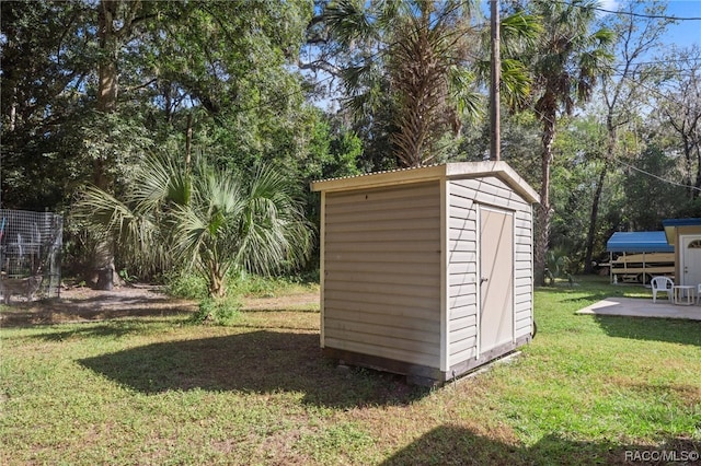 view of outbuilding with a yard