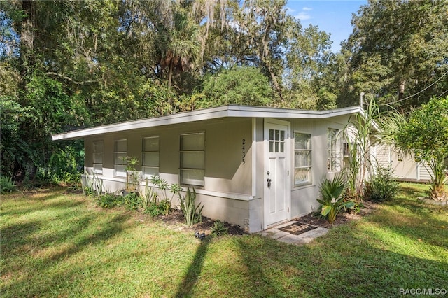 view of outbuilding featuring a yard