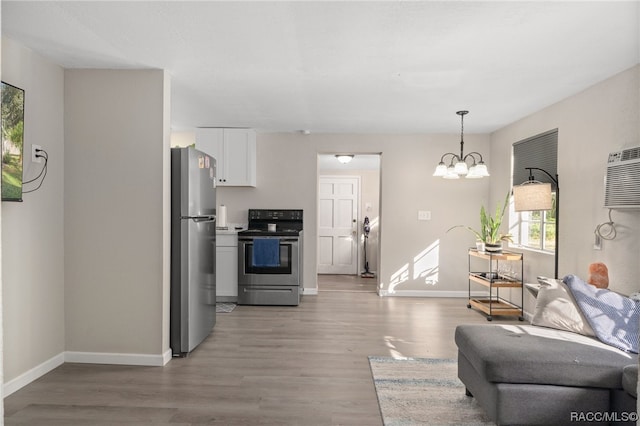 kitchen with dark hardwood / wood-style floors, white cabinetry, appliances with stainless steel finishes, and a chandelier