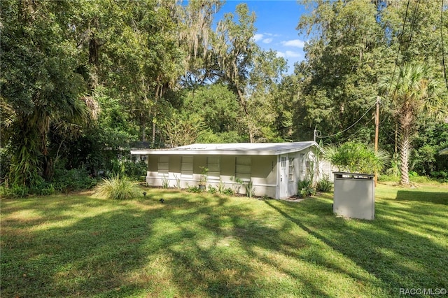 view of outdoor structure featuring a lawn