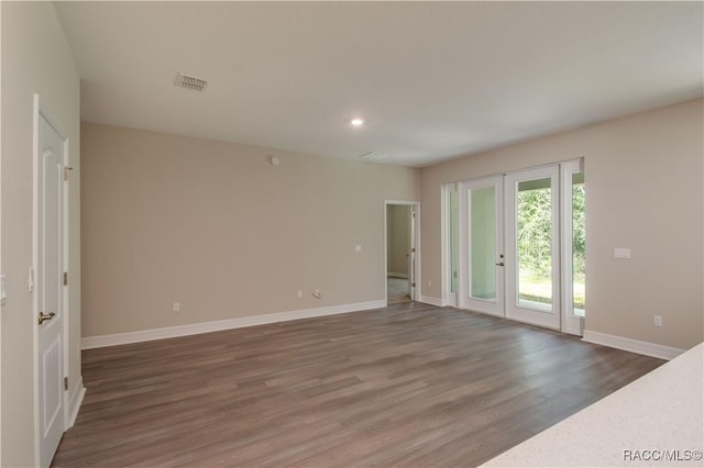 interior space with baseboards, recessed lighting, wood finished floors, and visible vents