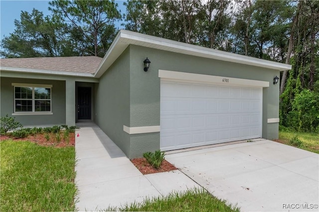 ranch-style home with an attached garage, roof with shingles, stucco siding, and driveway