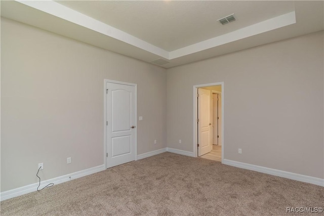 carpeted empty room featuring baseboards and visible vents