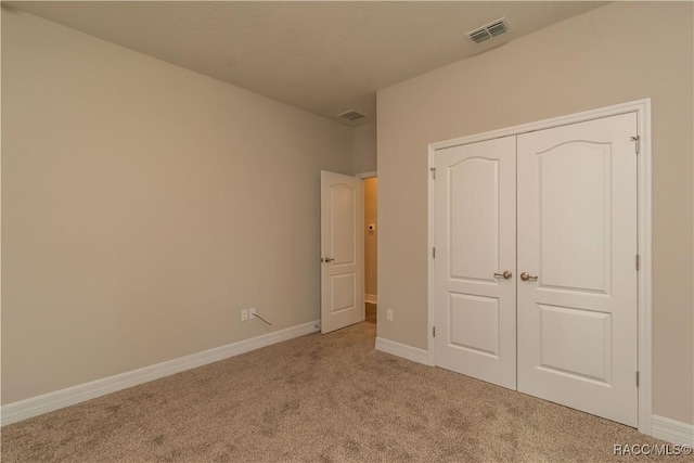 unfurnished bedroom featuring visible vents, baseboards, and carpet floors