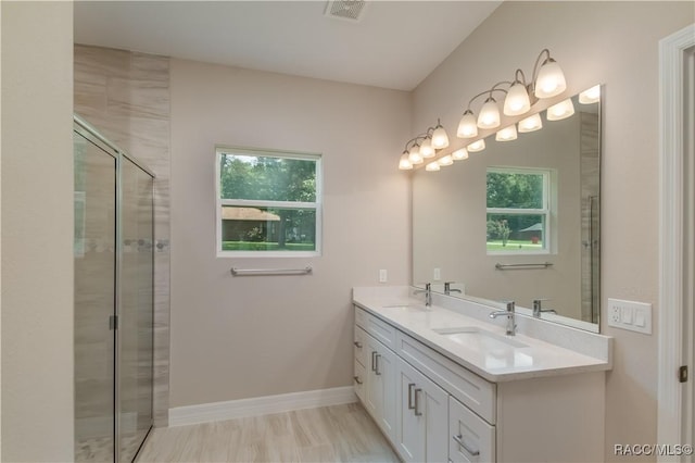 bathroom featuring visible vents, a healthy amount of sunlight, and a sink