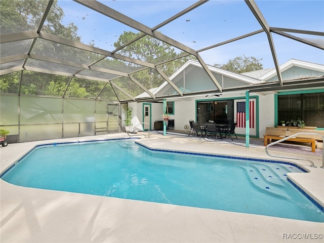 view of swimming pool with a lanai and a patio