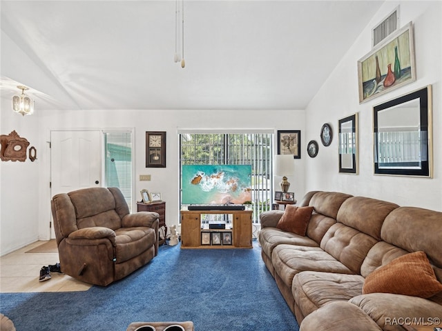 carpeted living room featuring high vaulted ceiling