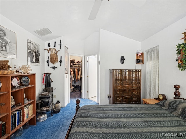 carpeted bedroom featuring a spacious closet, a closet, ceiling fan, and vaulted ceiling