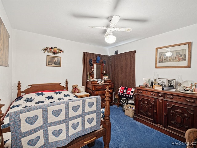 carpeted bedroom featuring ceiling fan and a textured ceiling