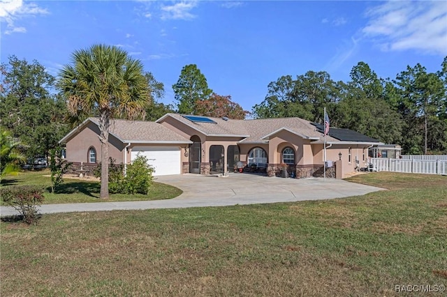 single story home featuring a front lawn and a garage