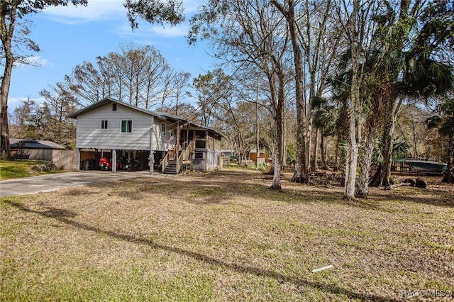 exterior space with a lawn and a carport