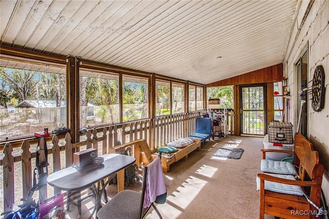 sunroom / solarium featuring lofted ceiling