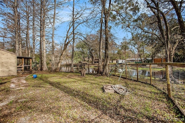 view of yard with central AC and a water view