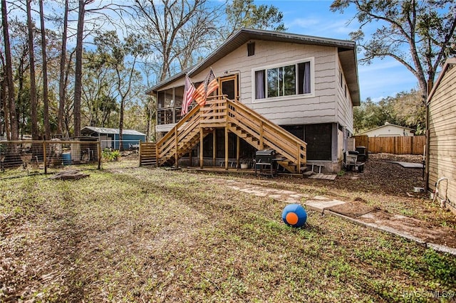 rear view of house featuring a sunroom