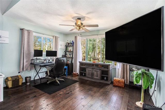 home office featuring ceiling fan, dark hardwood / wood-style floors, and a textured ceiling