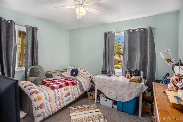 bedroom featuring multiple windows, ceiling fan, and carpet flooring