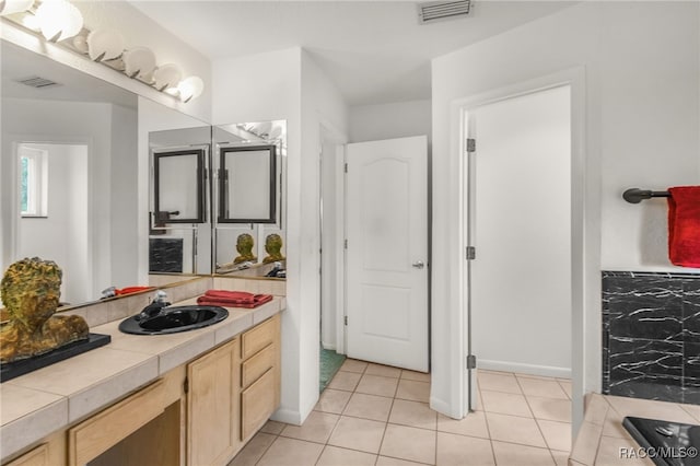 full bathroom featuring visible vents, baseboards, tile patterned floors, and vanity