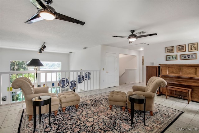 sitting room featuring visible vents, a ceiling fan, and light tile patterned floors