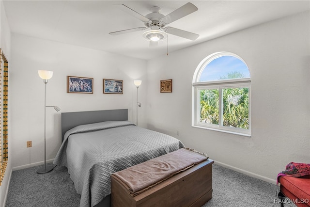 carpeted bedroom with baseboards and ceiling fan