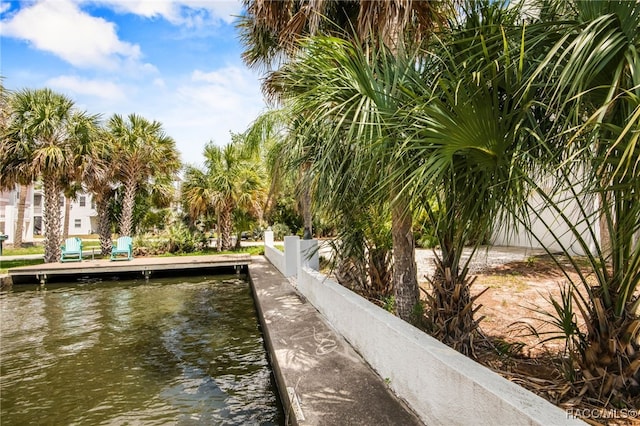 exterior space featuring fence and a water view