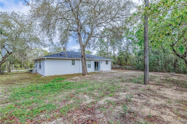 rear view of property featuring a fenced backyard