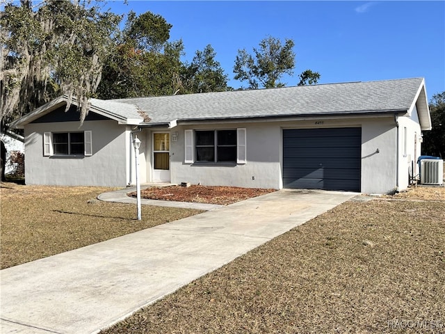 ranch-style home with central AC and a garage