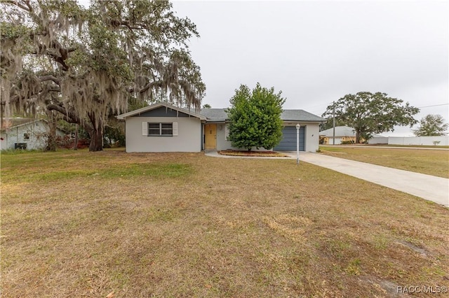 single story home with a front lawn and a garage