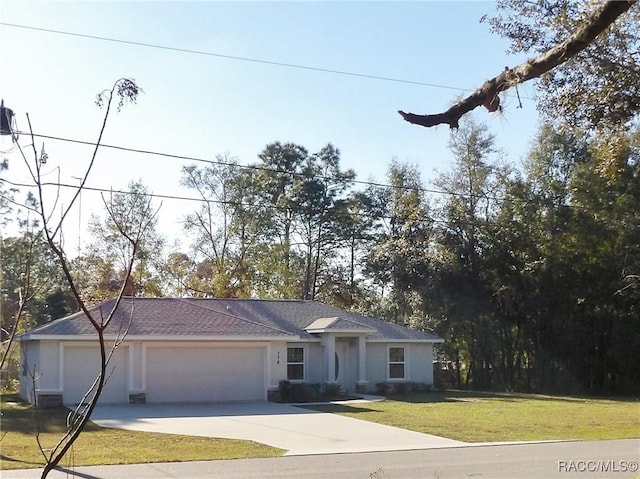 view of front of property with a garage and a front lawn