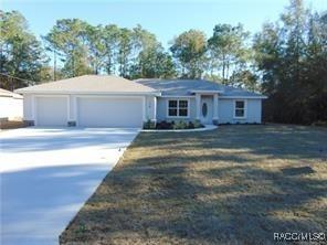 single story home with a front lawn and a garage