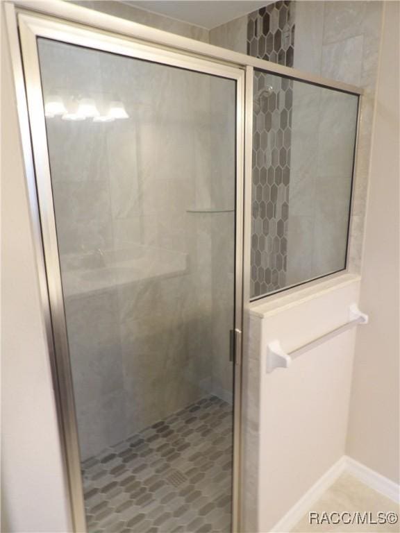 bathroom with a shower with shower door