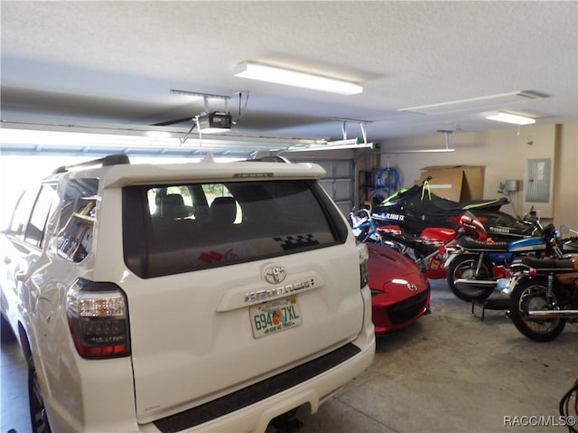 garage featuring a garage door opener and electric panel