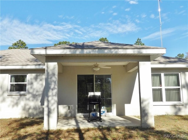 entrance to property with ceiling fan and a patio area