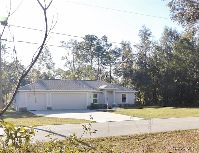 view of front of home featuring a garage and a front yard