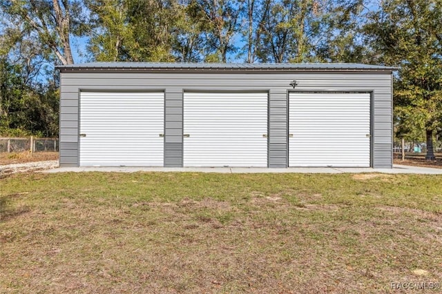 garage featuring a lawn