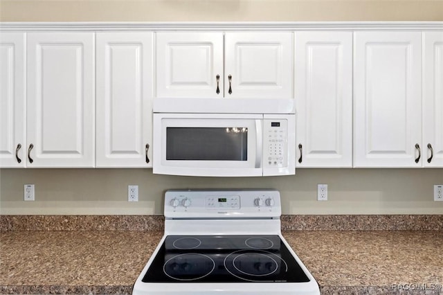 kitchen featuring white cabinetry and white appliances