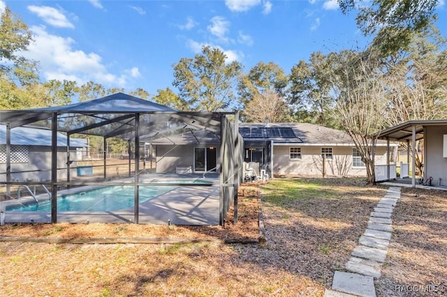 back of property with a lanai, a patio, and solar panels