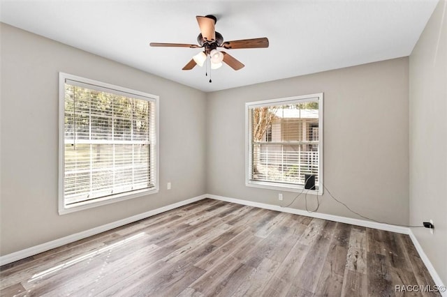 unfurnished room with ceiling fan and wood-type flooring