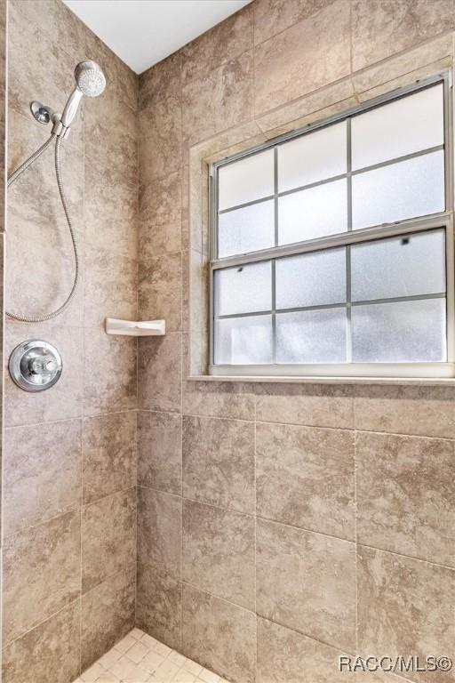 bathroom with tiled shower