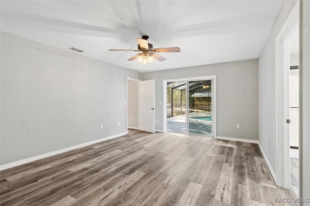 empty room with ceiling fan and light hardwood / wood-style floors