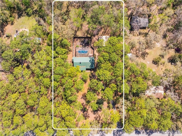 birds eye view of property with a forest view