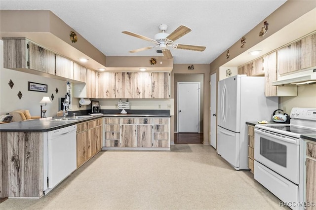 kitchen featuring ceiling fan, kitchen peninsula, sink, white appliances, and a textured ceiling