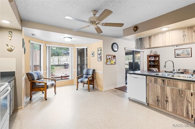 kitchen featuring a textured ceiling, stove, dishwasher, and sink